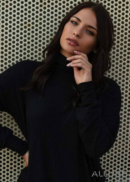 Woman wearing the Jasna high-neck dress – warm and stylish